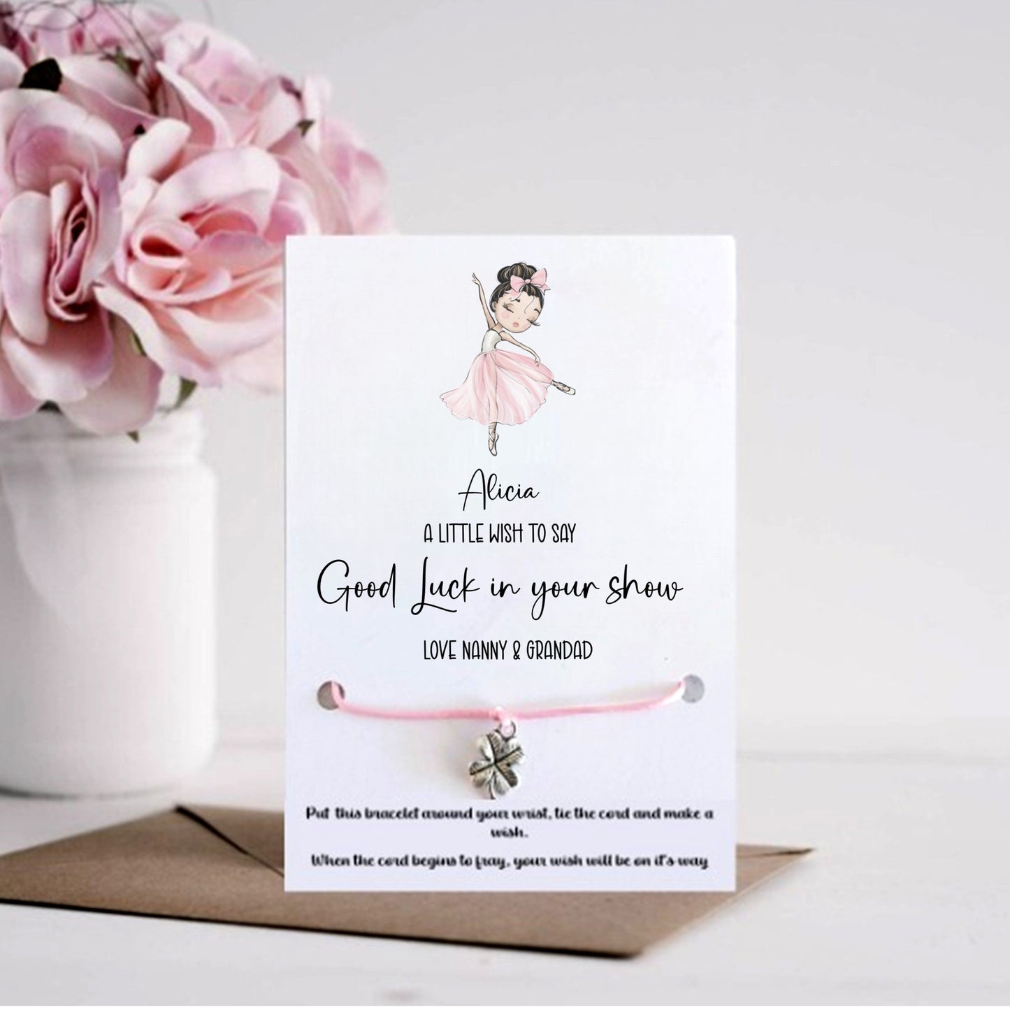 Card with a bracelet and flowers on a white background
