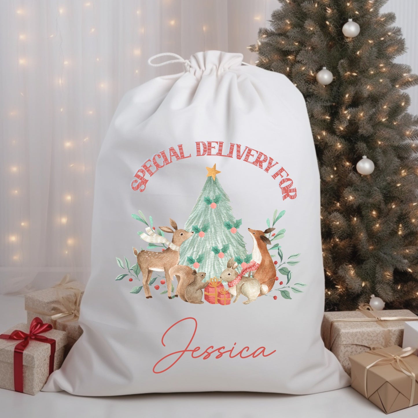 Personalized Christmas gift bag with festive design and text in front of a decorated Christmas tree.
