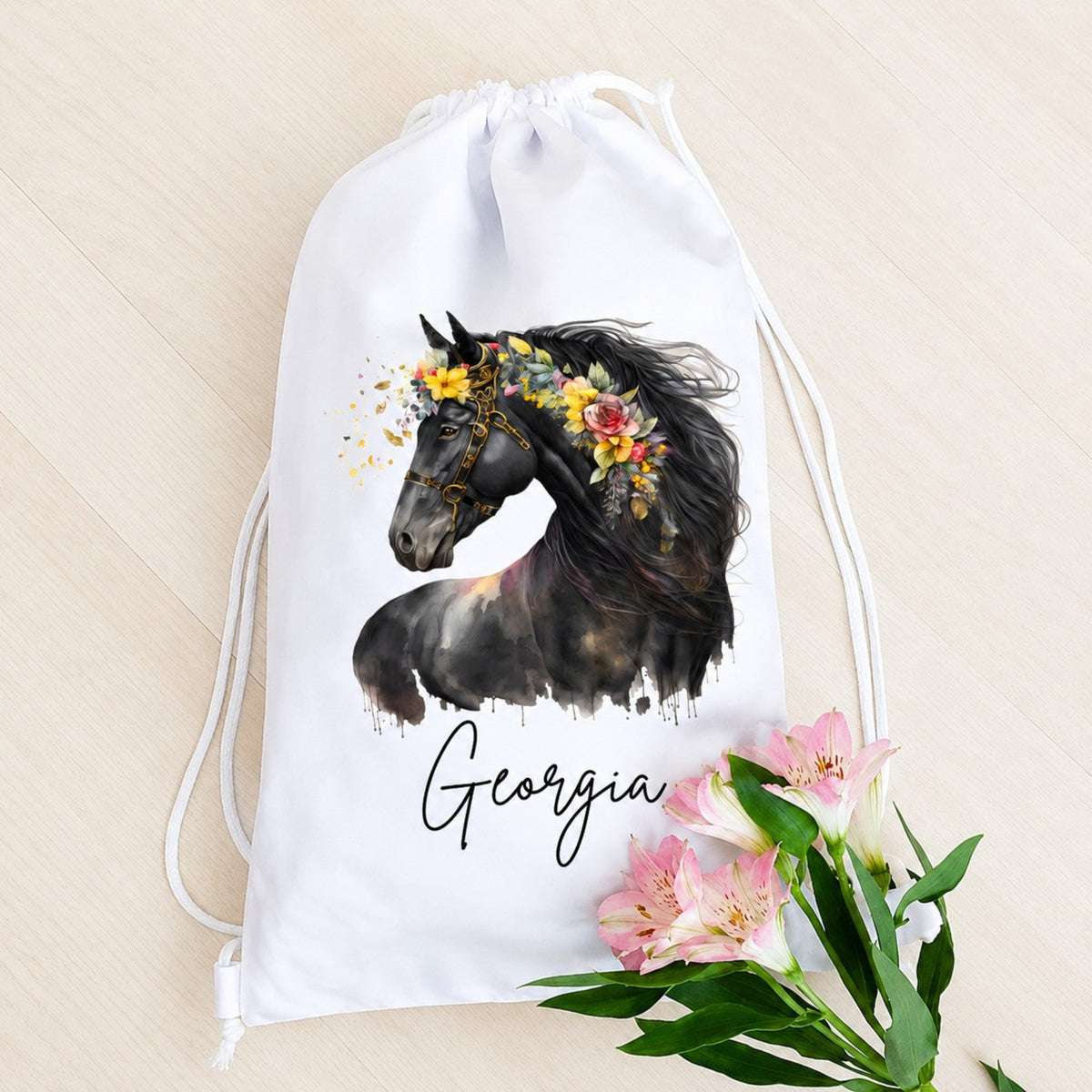 White drawstring bag with a horse and floral design, featuring the name 'Georgia', on a beige background.