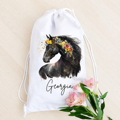 White drawstring bag with a horse and floral design, featuring the name 'Georgia', on a beige background.