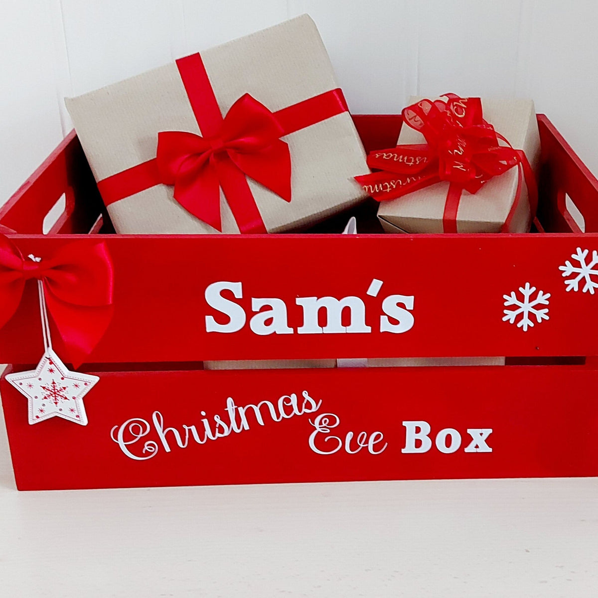 Red Christmas Eve Box' with gifts and bows on a white background