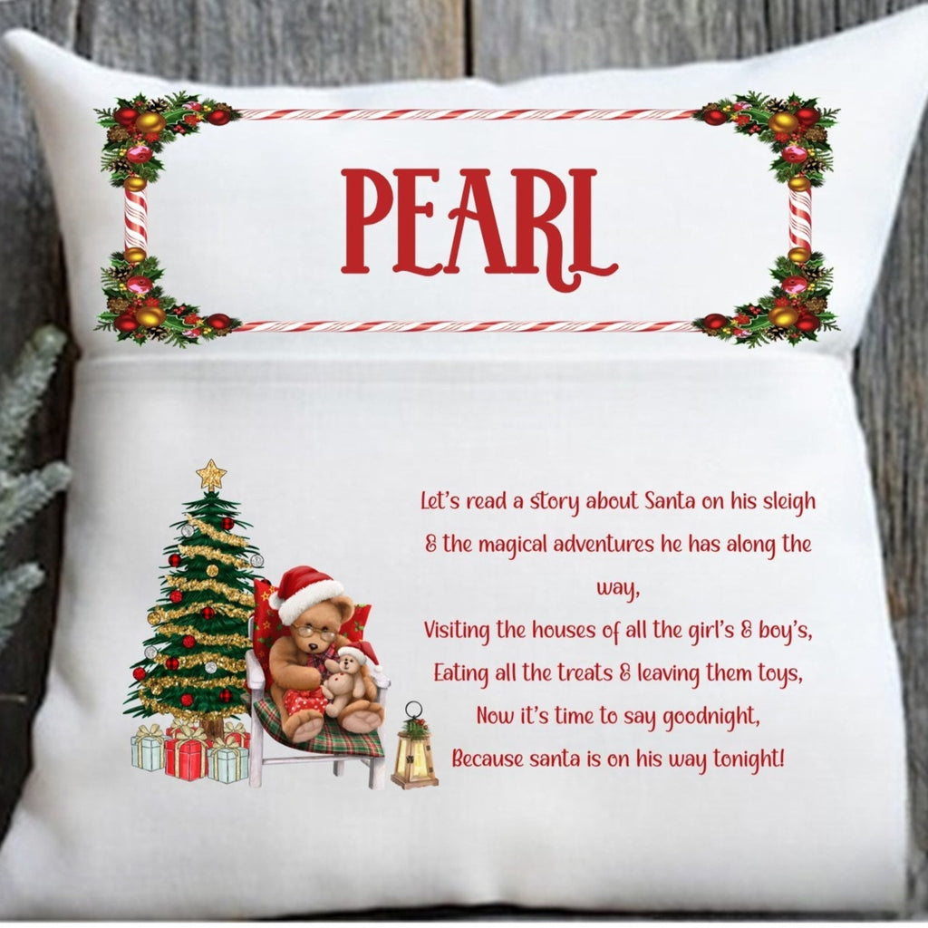 Decorative pillow with Christmas-themed design and text, featuring a teddy bear and Santa Claus.