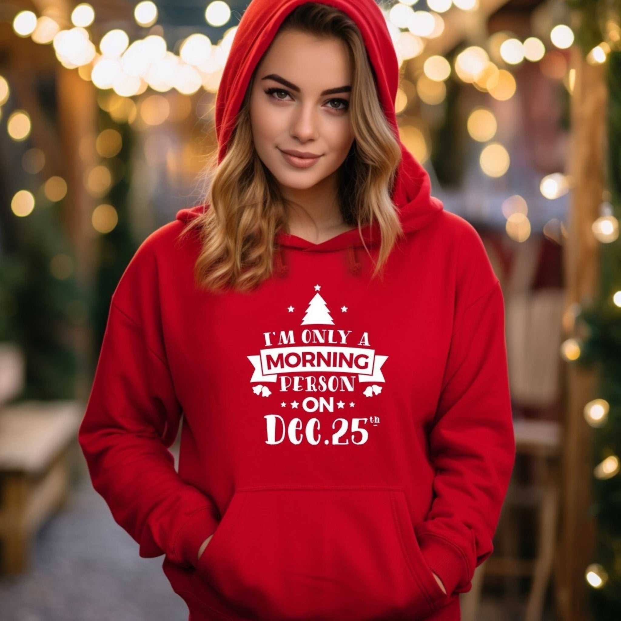 Person wearing a red hoodie with a Christmas-themed message in a festive setting.