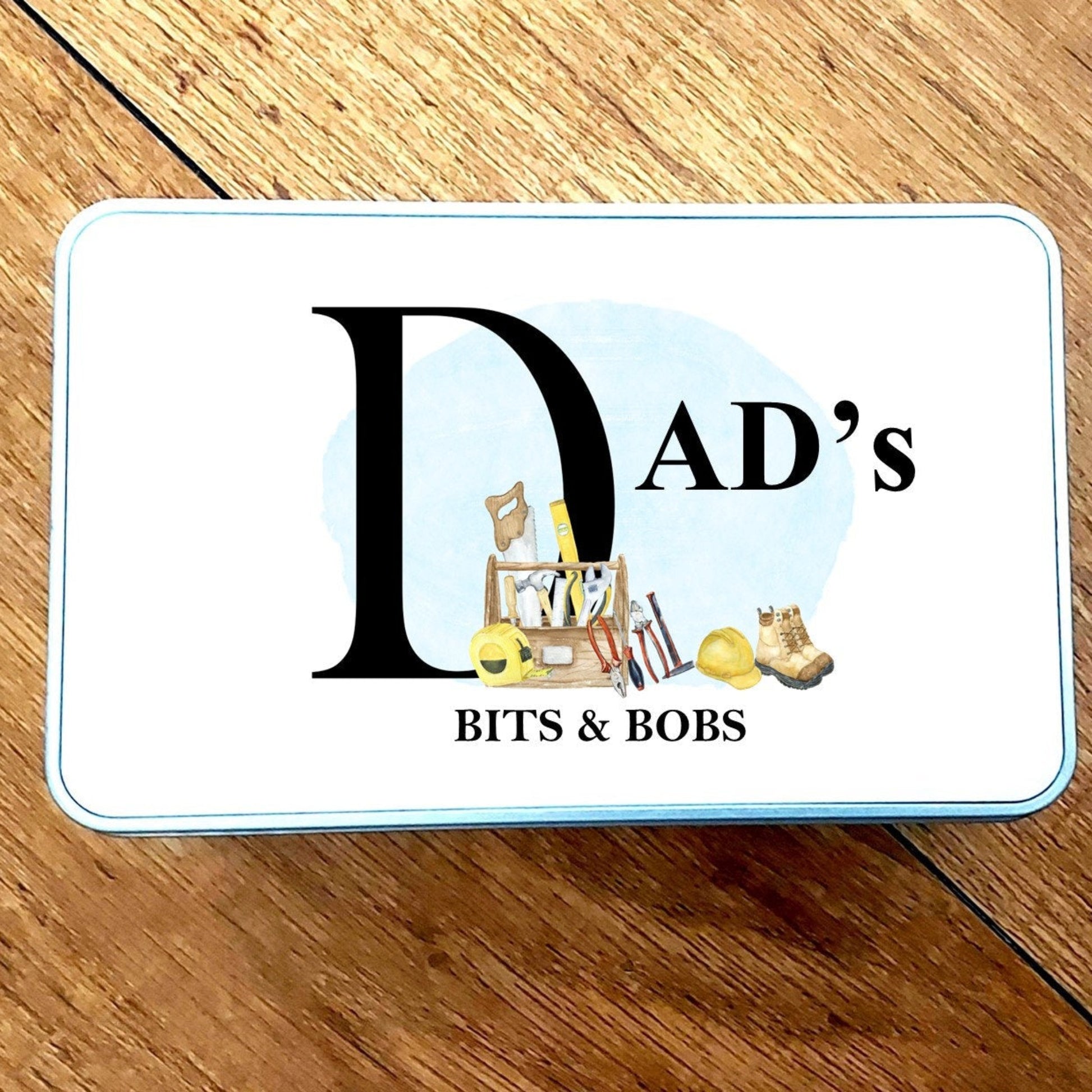 Card with 'Dad's Bits & Bobs' text on a wooden surface
