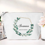 White pouch with green leaf design and 'Joanna Maid of Honour' text on a white background