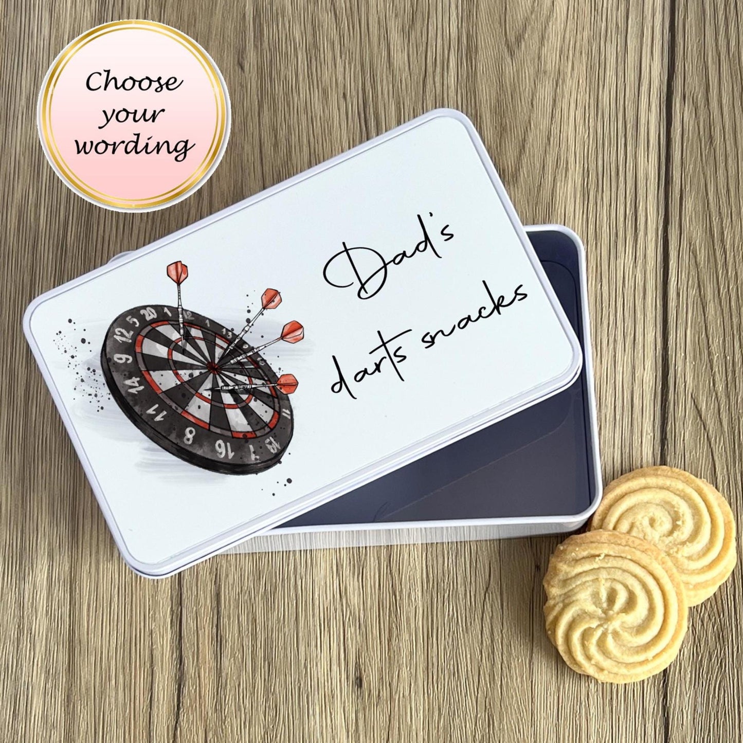 Dart-themed snack tin with cookies on a wooden surface