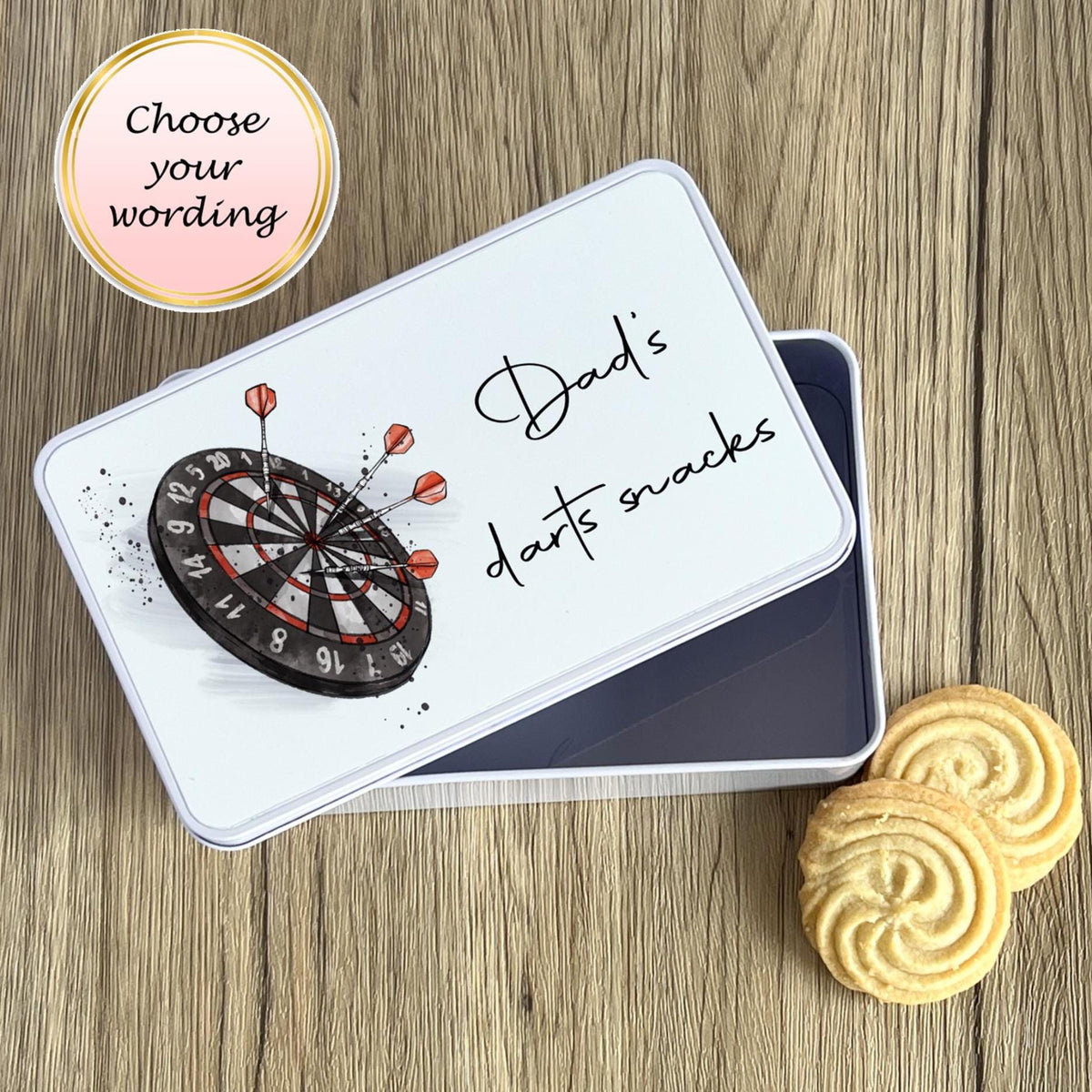 Dart-themed snack tin with cookies on a wooden surface