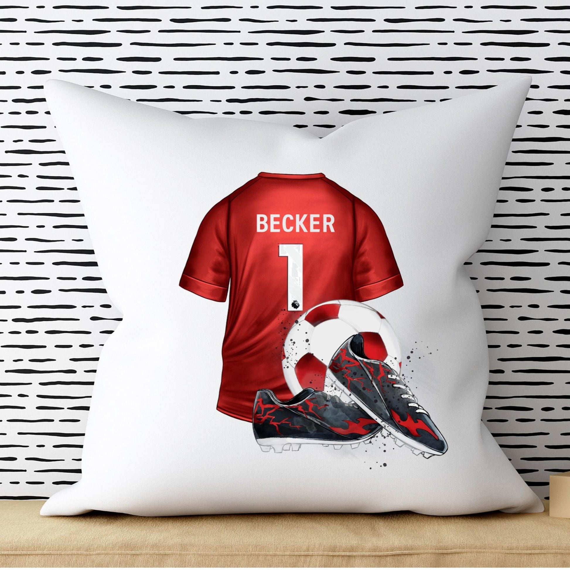 White pillow with a red sports jersey design featuring the name 'Becker' and number '1', against a black and white striped wall.