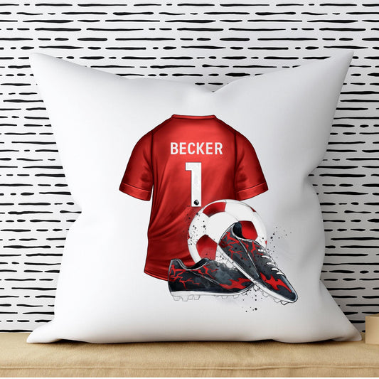 White pillow with a red sports jersey design featuring the name 'Becker' and number '1', against a black and white striped wall.