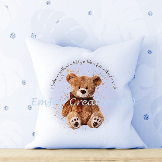A white cushion with a blue pattern featuring an illustration of a teddy bear and the text 'Every Crib' on it, presented in a room setting.